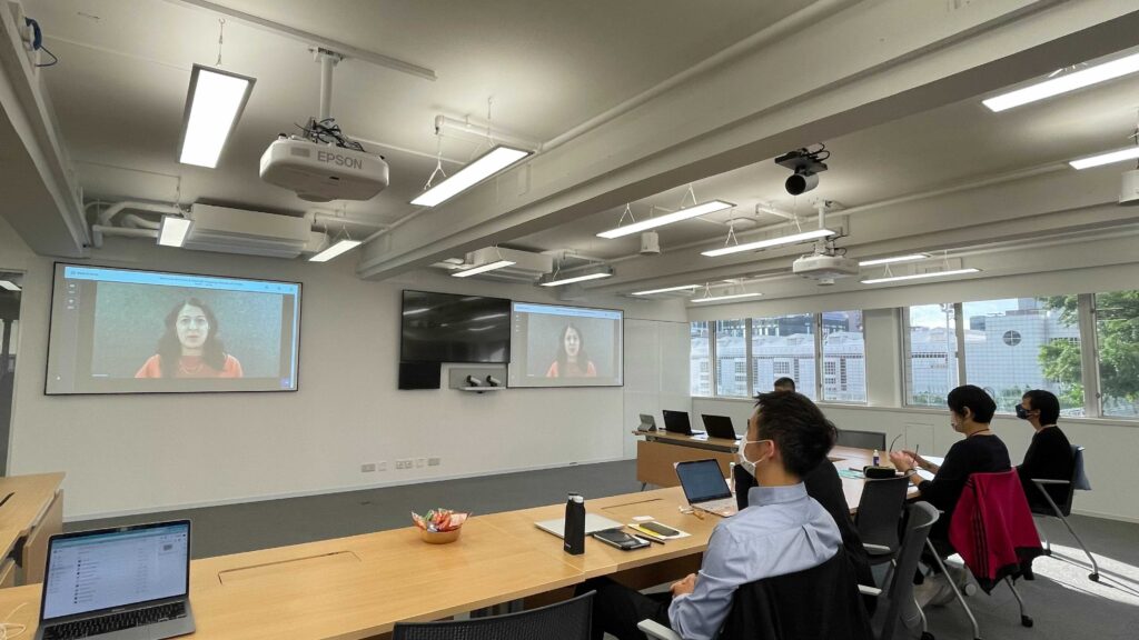 Photo of the APAC SAC team watching the 2021 SAC Annual Meeting on projector screens