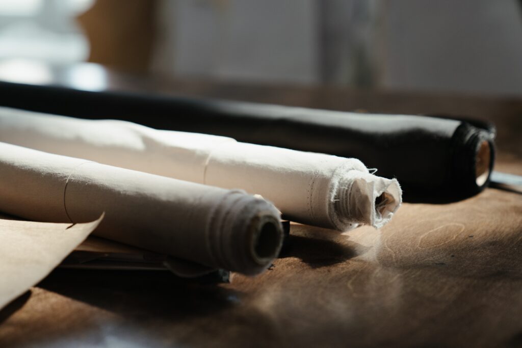 Photo of three rolls of fabric on a table