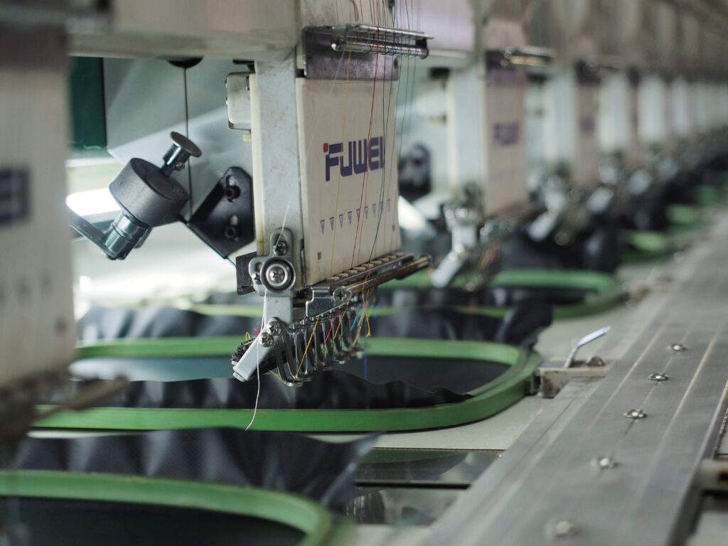 Close-up photo of an industrial sewing machine in factory