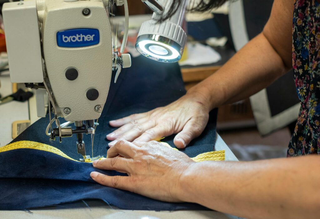 Close-up photo of a person's hands working at a sewing machine