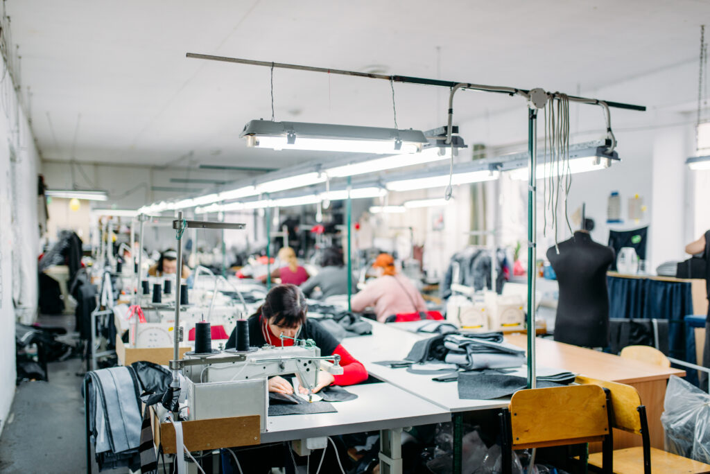 Woman working at a sewing machine in a factory