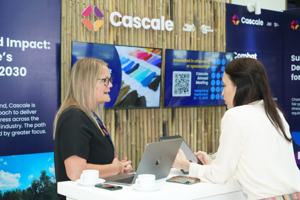 Katie Hess chats to a woman about Better Buying at the Cascale booth at the Cascale Forum: Ho Chi Minh City