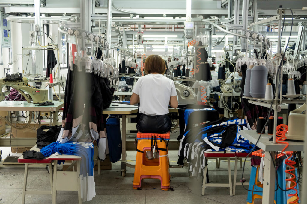 Detail of employee working in Chinese clothing factory