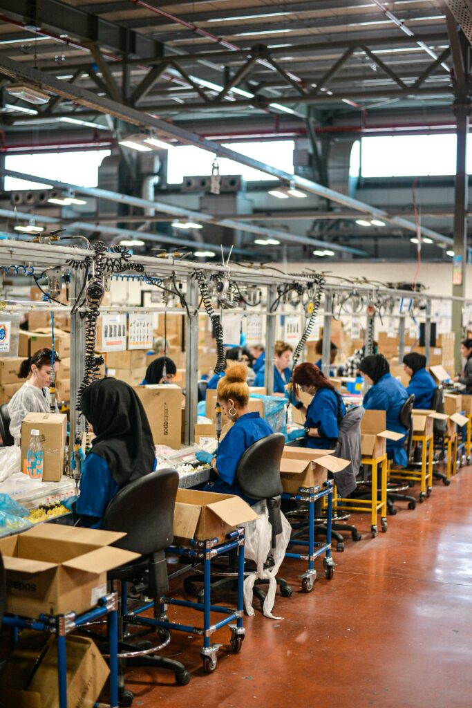 A wide-angle shot of workers in blue uniforms sewing